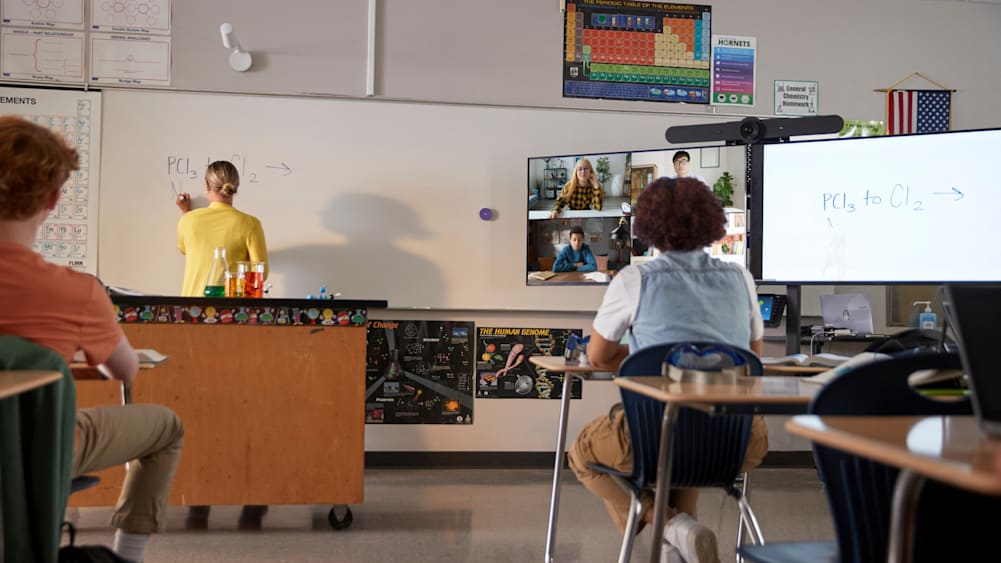 Teaching writing on a whiteboard in a hybrid learning classroom