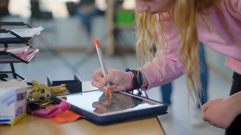Student using crayon digital pencil with ipad